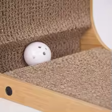 Close-up of corrugated cardboard surface and toy ball slot on L-shaped scratcher