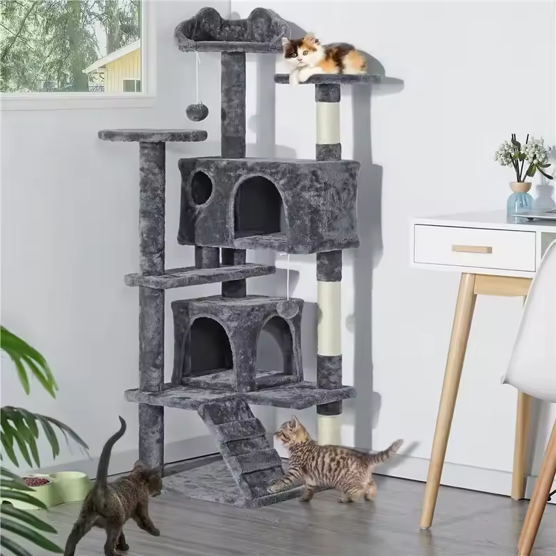Two cats playing on grey multi-level cat tree in living room – lifestyle photo